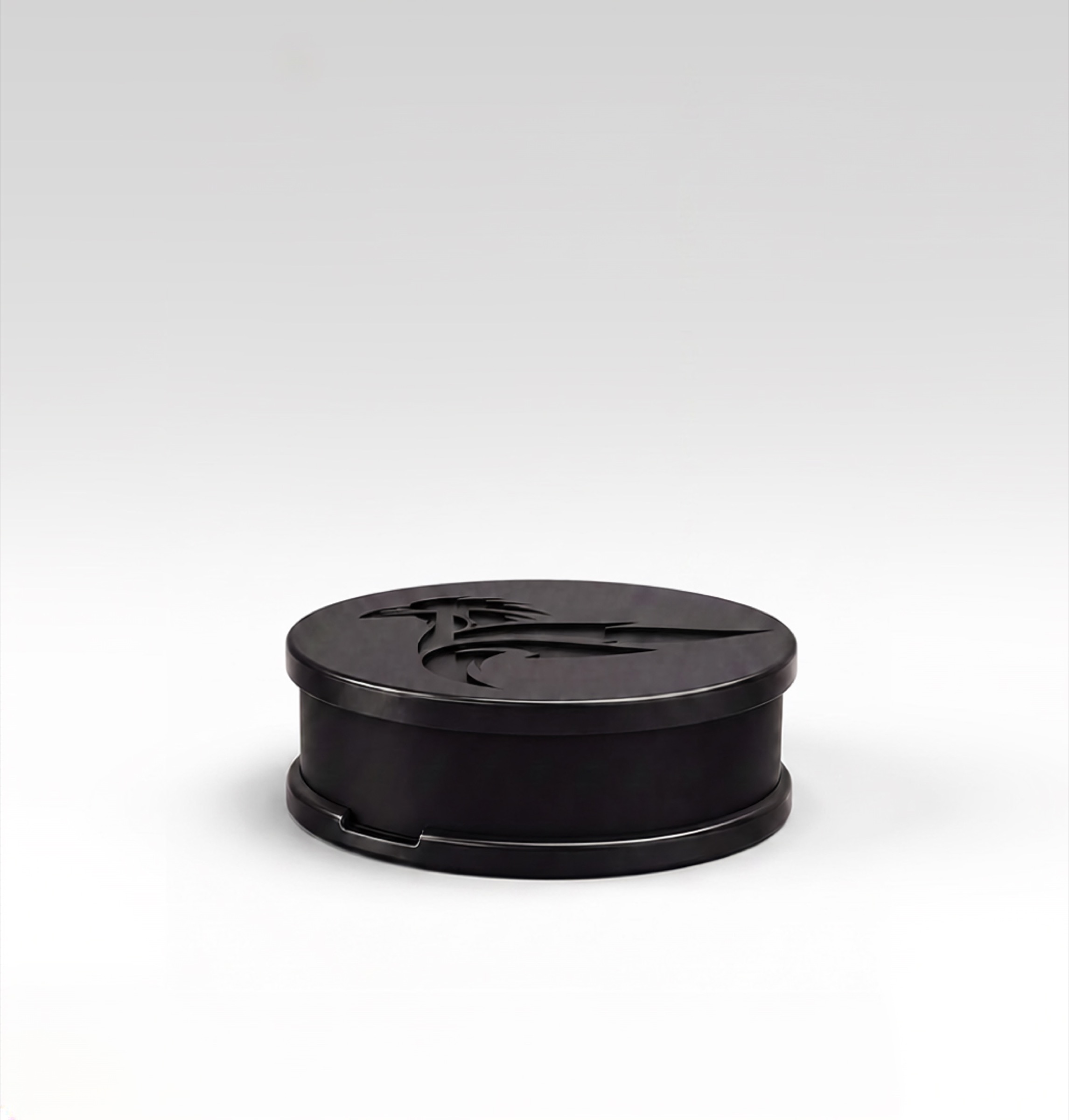 Raven Node, a compact matte black disc embossed with the Raven Forge mark